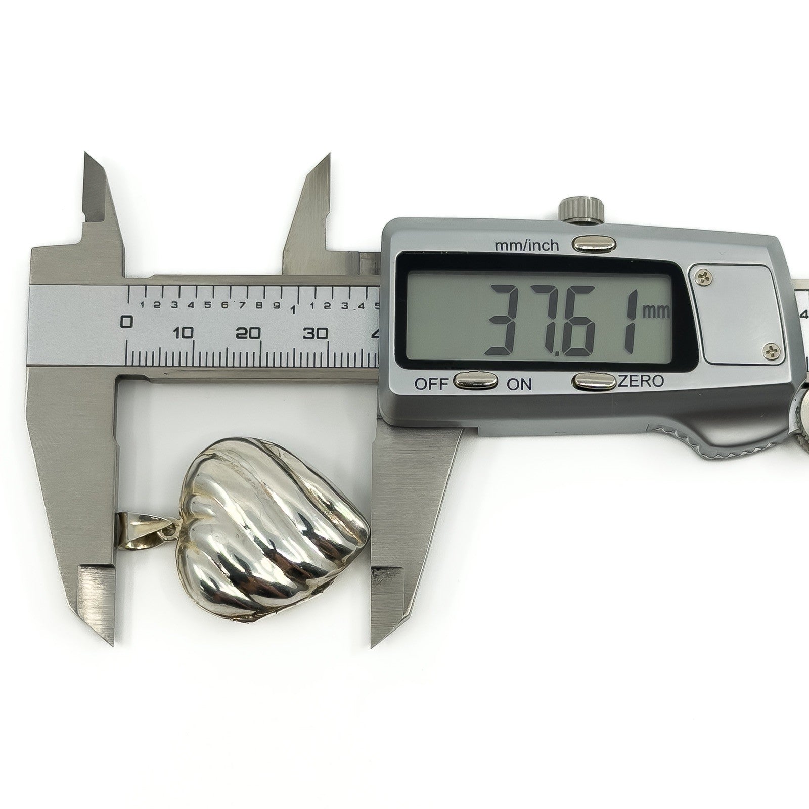 Vintage sterling silver puffy heart locket measured with digital calipers at approximately 37.6mm.