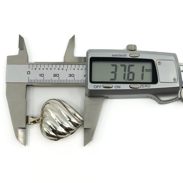 Vintage sterling silver puffy heart locket measured with digital calipers at approximately 37.6mm.