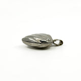 Side profile of the vintage sterling silver puffy heart photo locket showing its depth.