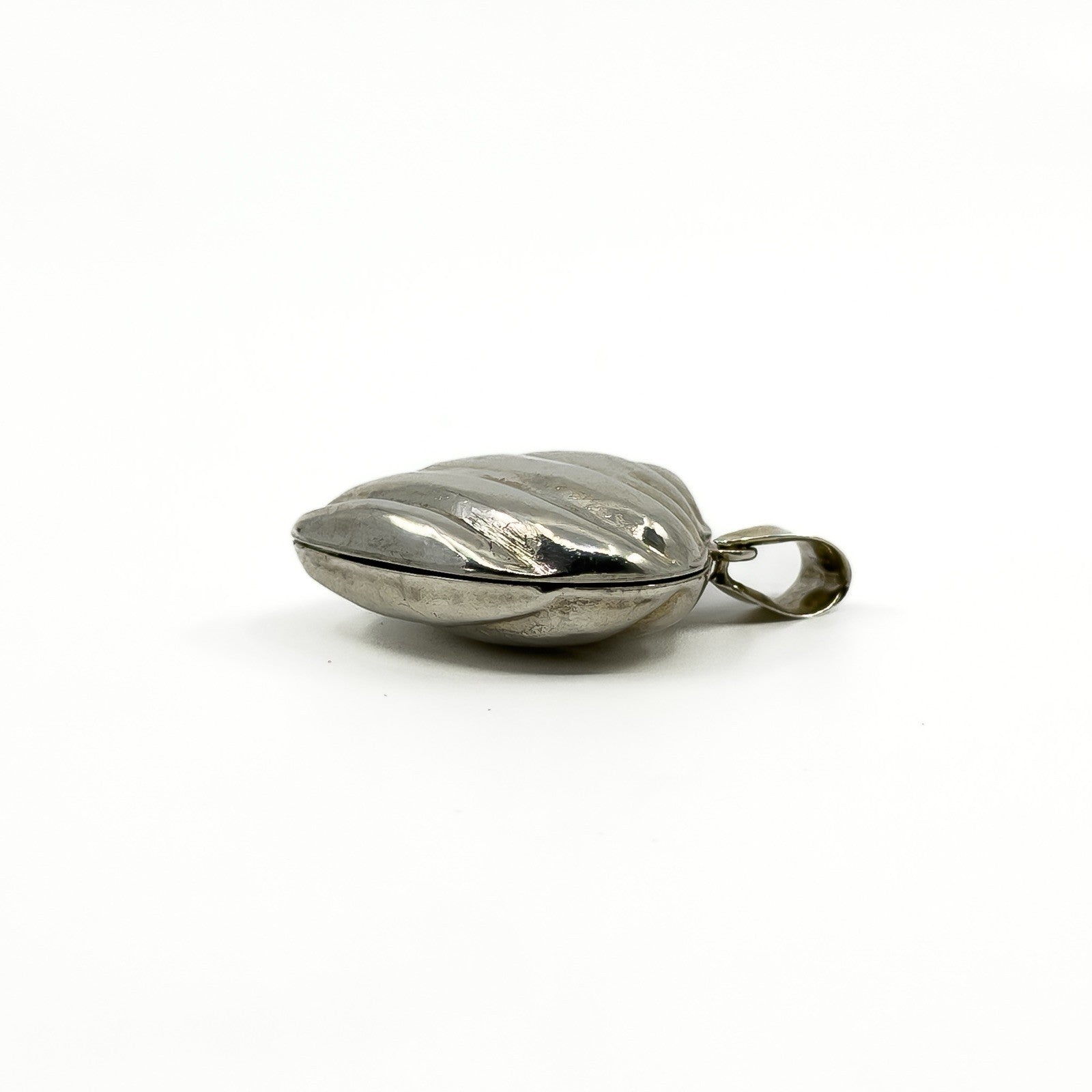 Side profile of the vintage sterling silver puffy heart photo locket showing its depth.