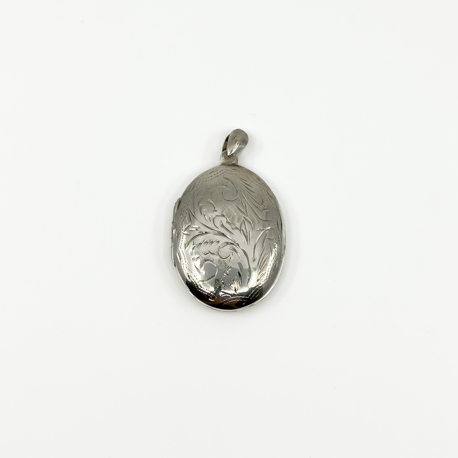 Vintage sterling silver oval photo locket with foliate engraving and polished bail