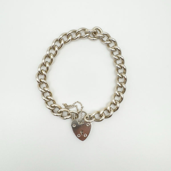 Vintage sterling silver curb bracelet with heart padlock clasp and safety chain