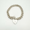Vintage silver charm bracelet with heart padlock clasp laid flat