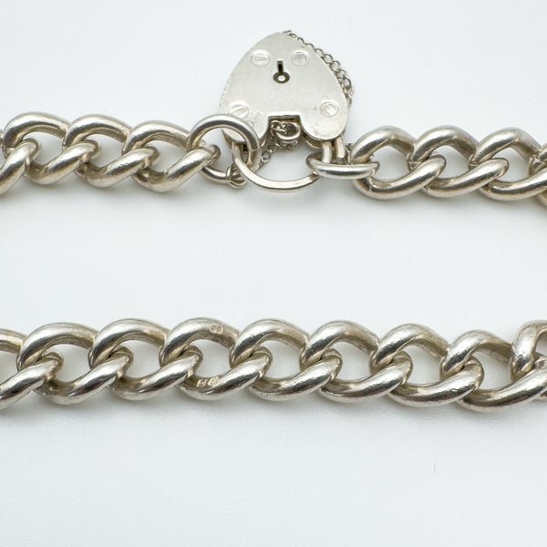 Silver bracelet with solid curb links and visible hallmarks
