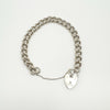 Open view of silver bracelet with clasp and safety chain extended