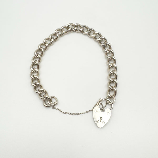Open view of silver bracelet with clasp and safety chain extended