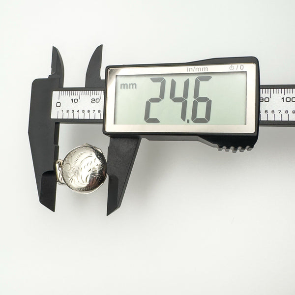 Caliper measuring silver locket width 24.6mm