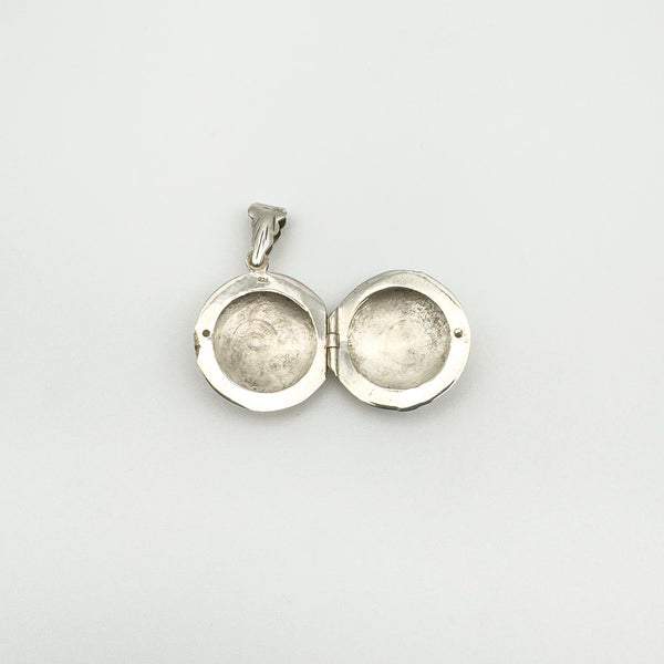 Open sterling silver locket showing interior and 925 stamp