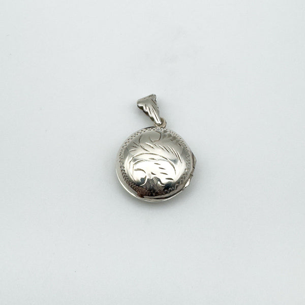 Sterling silver engraved locket pendant photographed flat