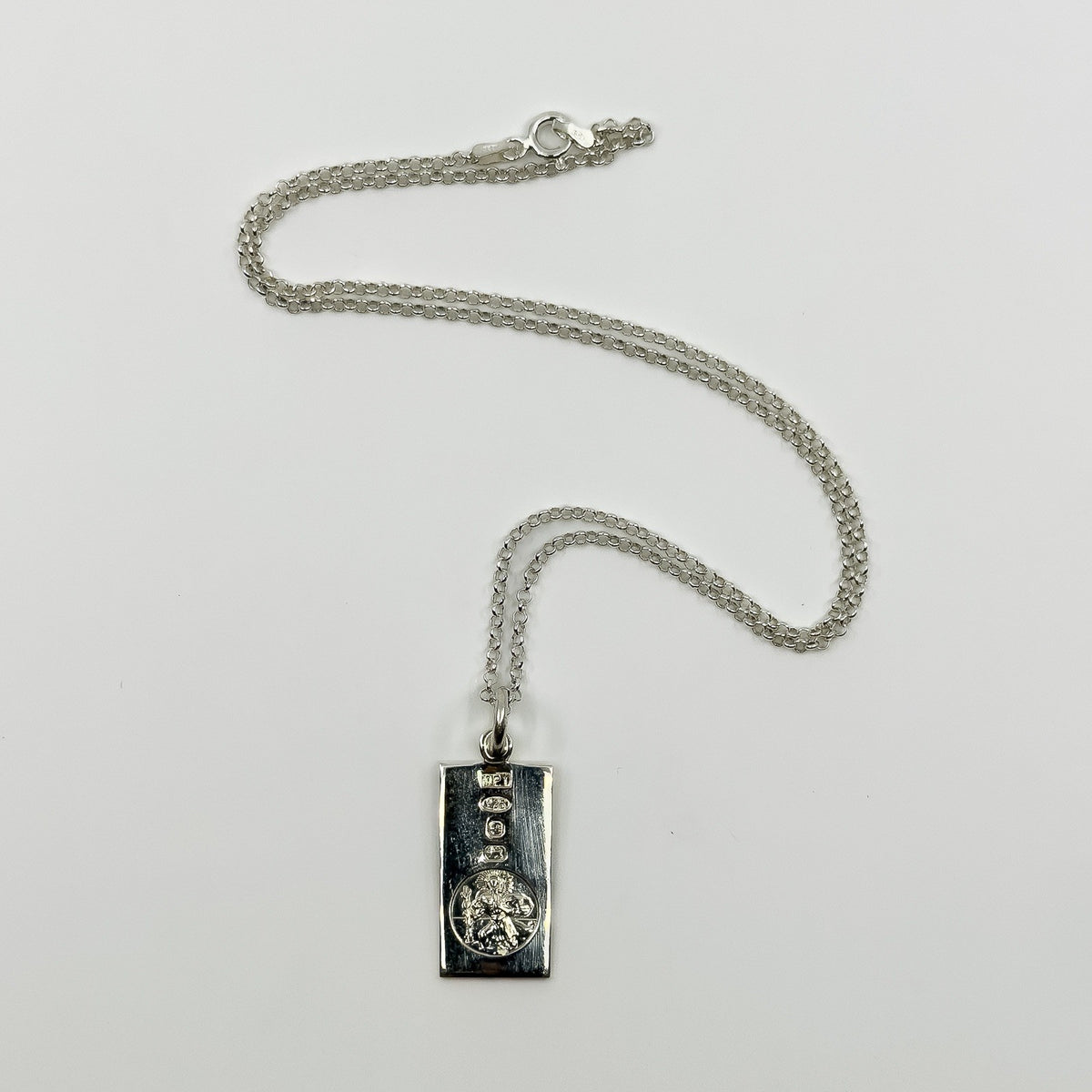 Vintage sterling silver St Christopher ingot pendant with 18 inch chain laid flat