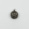 Vintage sterling silver Virgin Mary Christian photo locket pendant with jump ring on white background.