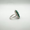 Angled shot of vintage silver ring with green turquoise