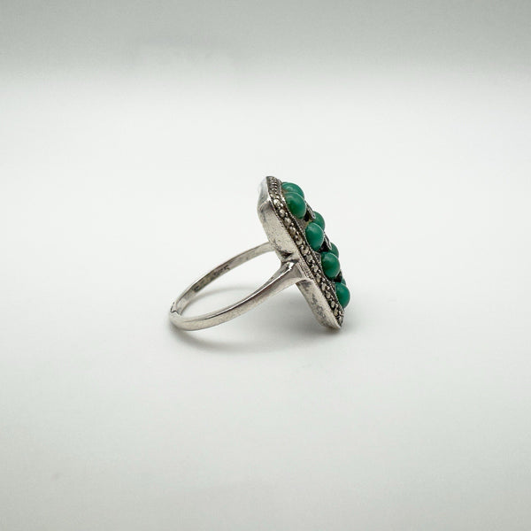 Angled shot of vintage silver ring with green turquoise