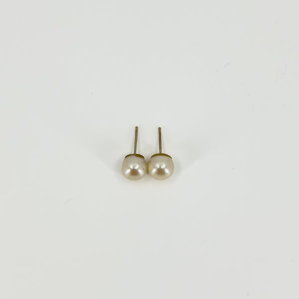 Rear view of vintage 9ct gold pearl stud earrings showing the post fittings and gold settings.