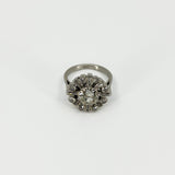Front view of vintage platinum 2.70ct diamond cluster ring with old cut centre and geometric surround.