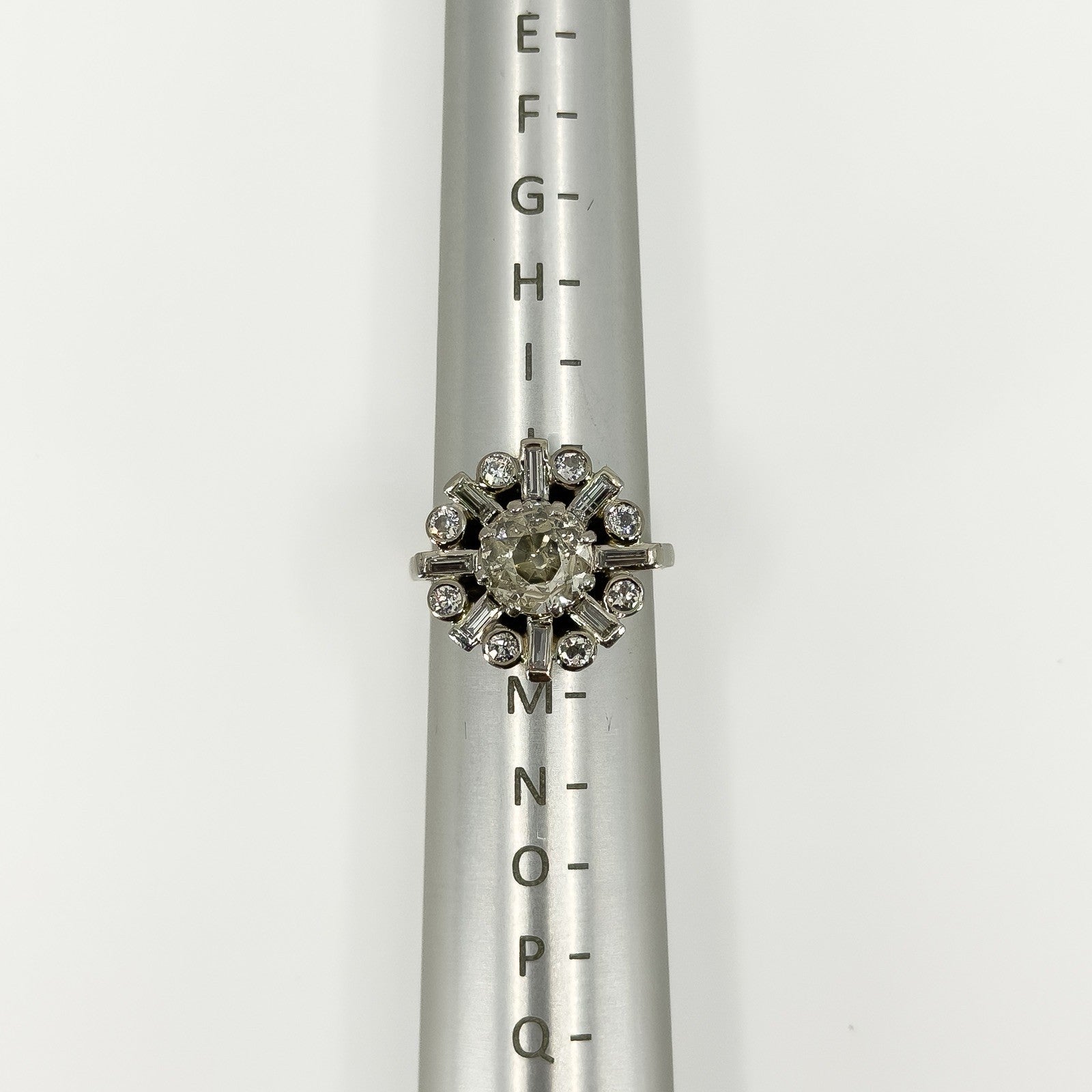 Vintage platinum 2.70ct diamond cluster ring shown front-on on a ring mandrel at UK Size K.