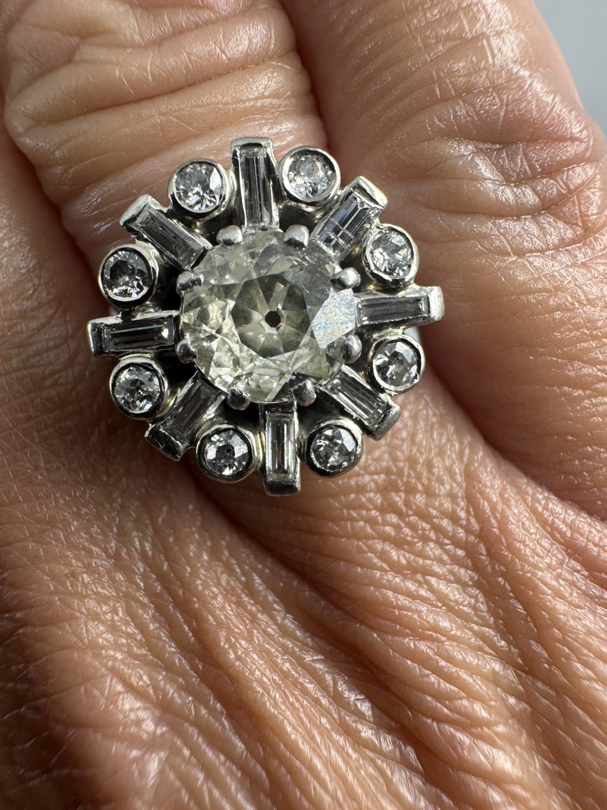 Vintage platinum 2.70ct diamond cluster ring worn on the hand, showing the scale of the 17mm cluster.