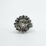Vintage platinum diamond cluster ring with old cut centre and alternating round and baguette diamonds.
