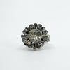 Vintage platinum diamond cluster ring with old cut centre and alternating round and baguette diamonds.