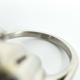 Close-up of the PLAT stamp inside the band of the vintage platinum diamond cluster ring.