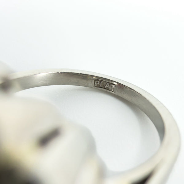 Close-up of the PLAT stamp inside the band of the vintage platinum diamond cluster ring.