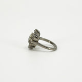 Opposite side view of vintage platinum diamond cluster ring showing the raised cluster and tapered shoulder.
