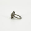Opposite side view of vintage platinum diamond cluster ring showing the raised cluster and tapered shoulder.