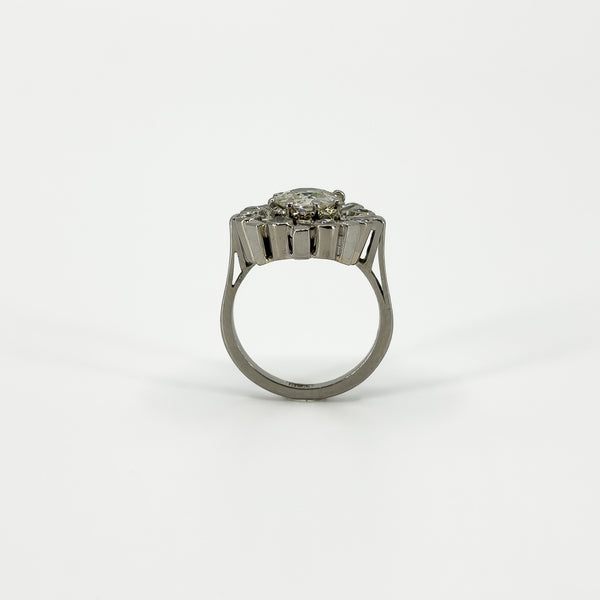 Rear profile of vintage platinum diamond cluster ring showing the raised setting and plain band.