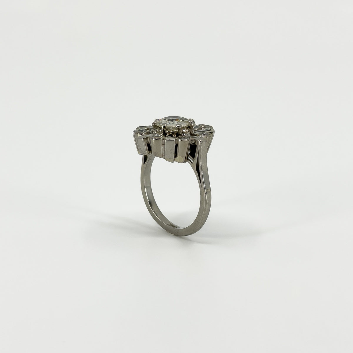 Rear view of vintage platinum diamond cluster ring showing the elevated setting and open gallery.