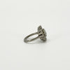 Side profile of vintage platinum diamond cluster ring showing the raised setting and tapered platinum band.
