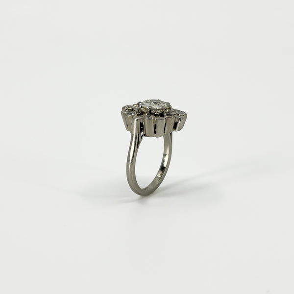 Side profile of vintage platinum diamond cluster ring showing the elevated cluster setting and platinum band.