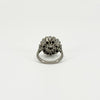 Underside of vintage platinum diamond cluster ring showing the open-backed gallery and platinum band.