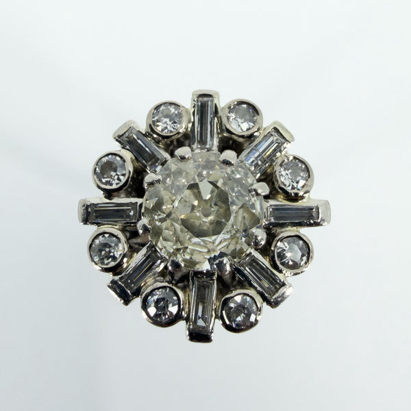 Close-up of vintage platinum cluster ring with 1.50ct estimated old cut centre and surrounding diamonds.