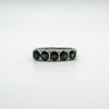 Close-up of vintage sterling silver ring with five dark blue sapphires in a claw setting