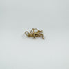 Flat-lay of vintage 9ct gold Sagittarius archer charm showing sculpted form