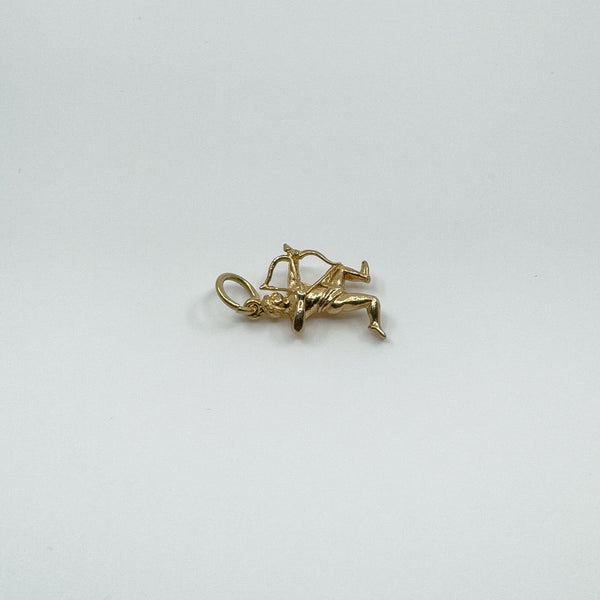Flat-lay of vintage 9ct gold Sagittarius archer charm showing sculpted form