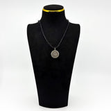 Vintage sterling silver Virgin Mary Christian photo locket pendant shown on a black display bust.
