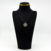 Vintage sterling silver Virgin Mary Christian photo locket pendant shown on a black display bust.
