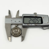 Digital caliper measuring the vintage sterling silver Virgin Mary locket pendant at approximately 24.05mm.