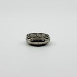 Side view of vintage sterling silver Virgin Mary photo locket showing the hinge and rounded case.