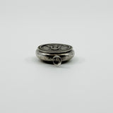 Low side view of vintage sterling silver Virgin Mary photo locket pendant with jump ring.