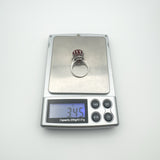 Digital scale showing weight of sterling silver carnelian ring as 3.4g