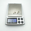 Digital scale showing pair of sterling silver earrings weighing 0.73g