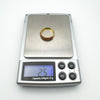 Gold-plated ruby ring on digital scale showing 2.51g weight