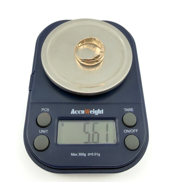 Antique 12ct gold band ring shown on digital scales, weight approx 5.6g