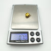 Digital scale showing 9ct gold sea shell pendant weighs 0.7g