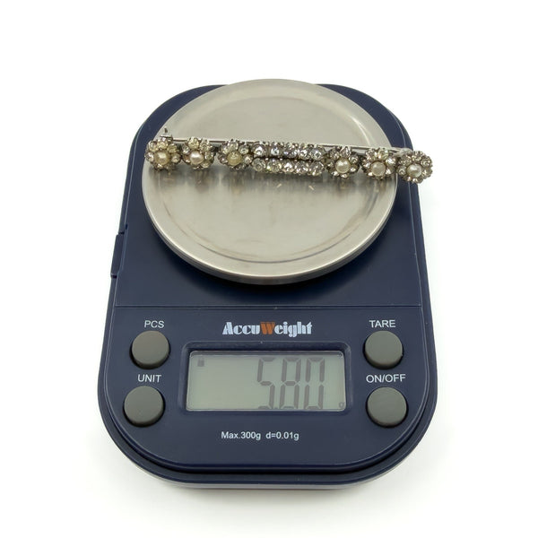 Antique sterling silver paste and pearl bar brooch on scales showing approx 5.80g.