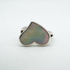 Bezel set heart-shaped white mother of pearl ring shown at an angle