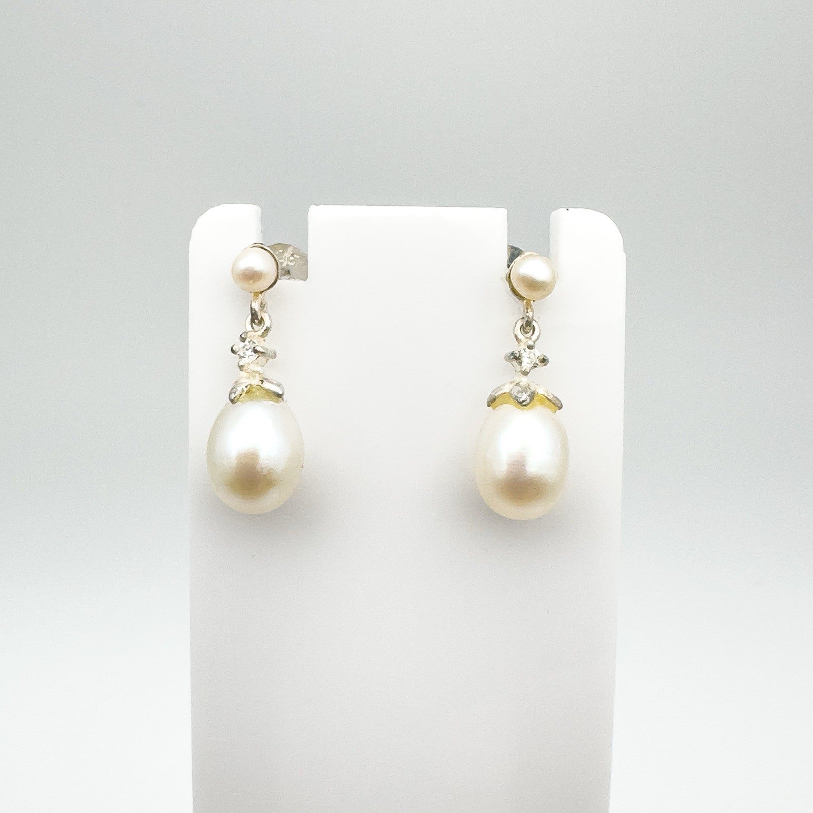Front view of white pearl and CZ drop earrings in sterling silver 925