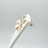 Side angle showing both white pearl drop earrings on stand